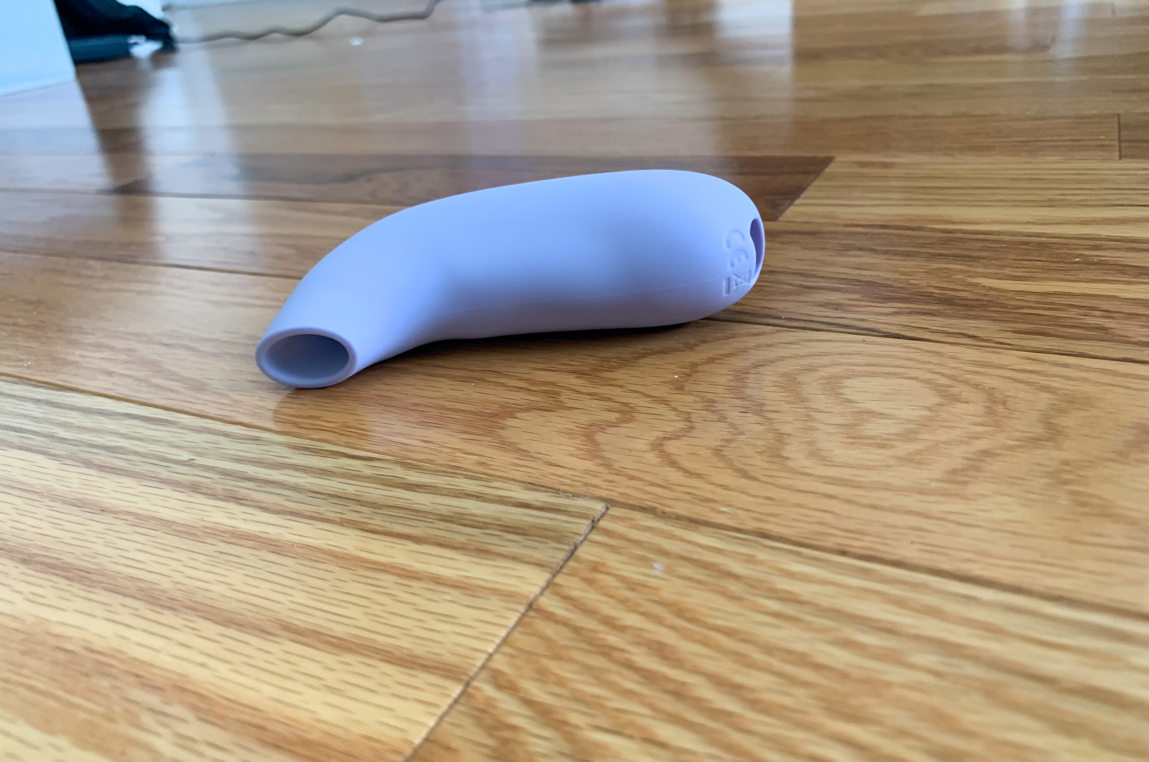 Dame Aer placed on side on wooden floor